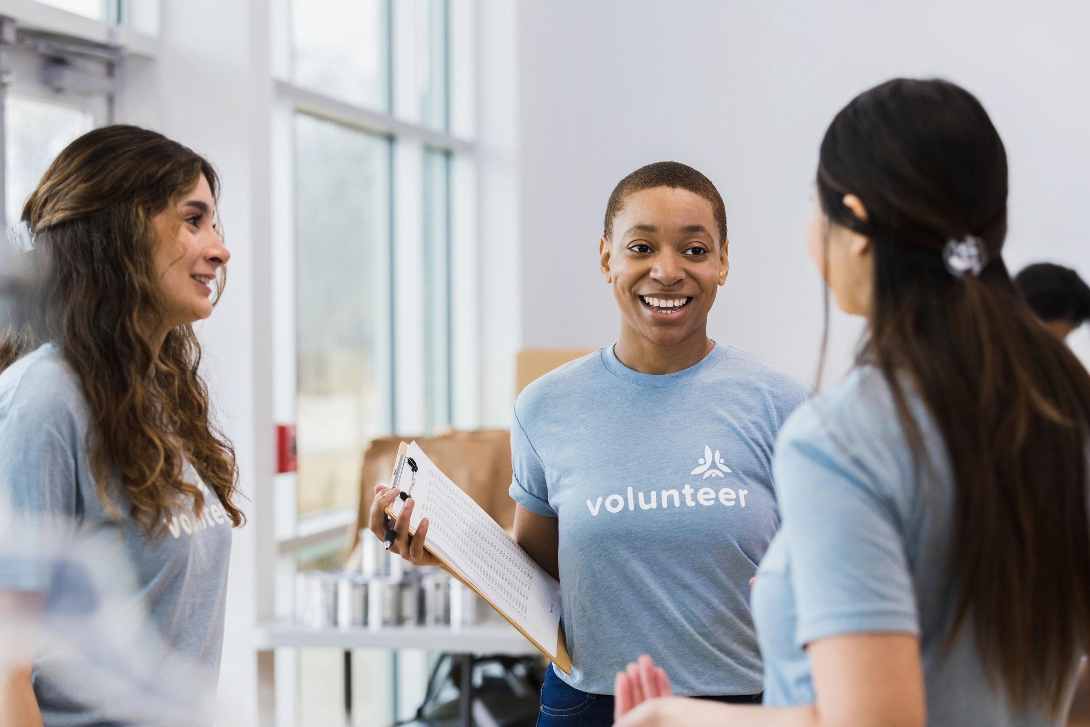 Women volunteering and talking at a community event