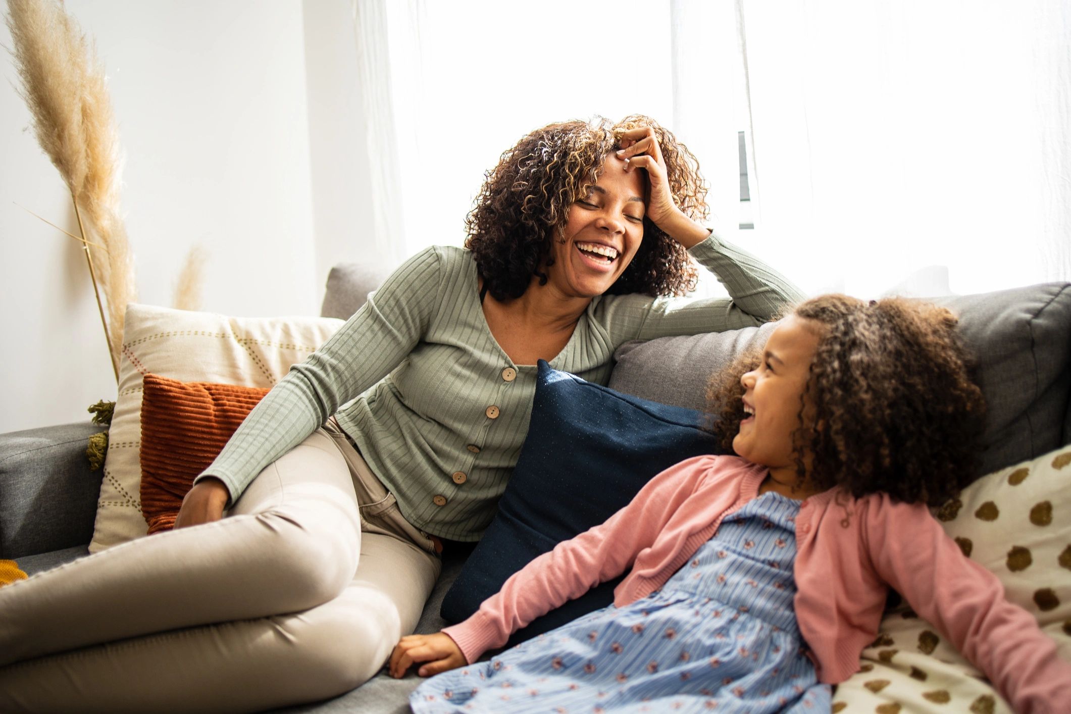 Mother and daughter talking and laughing at home