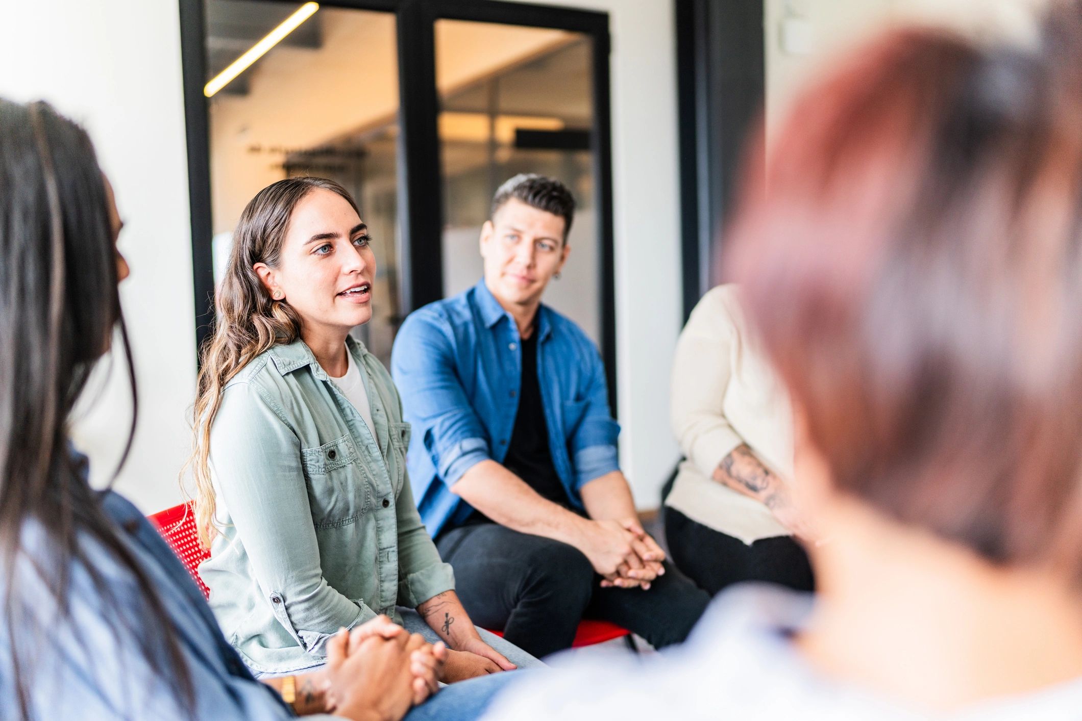 Woman speaking in a supportive group setting