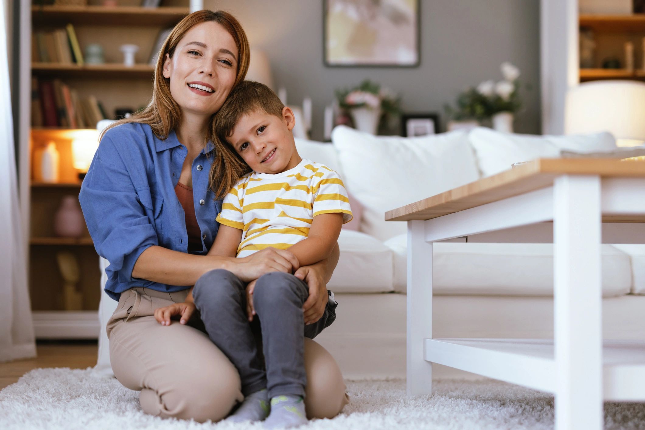 Mother and son embracing and smiling at home